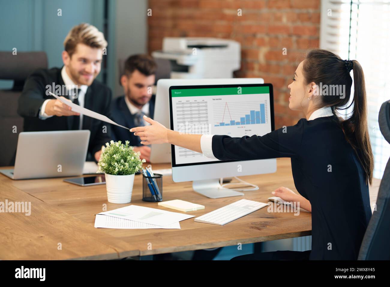 Employees work in the office, co-workers work on a common project Stock Photo