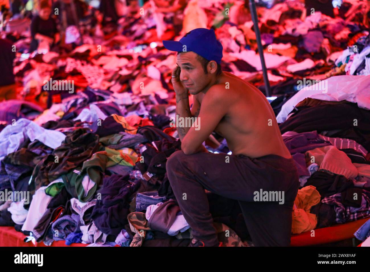 Mexico City, Mexico. 27th Mar, 2024. March 27, 2024, Mexico City, Mexico: A vendor offers second-hand clothes at a low price at the open-air market 'El Salado' located in the Iztapalapa. The price of the clothing ranges from 10 pesos to 300 pesos, depending on the quality of the clothing. on March 27, 2024 in Mexico City, Mexico. (Photo by Ian Robles/ Eyepix Group/Sipa USA) Credit: Sipa USA/Alamy Live News Stock Photo