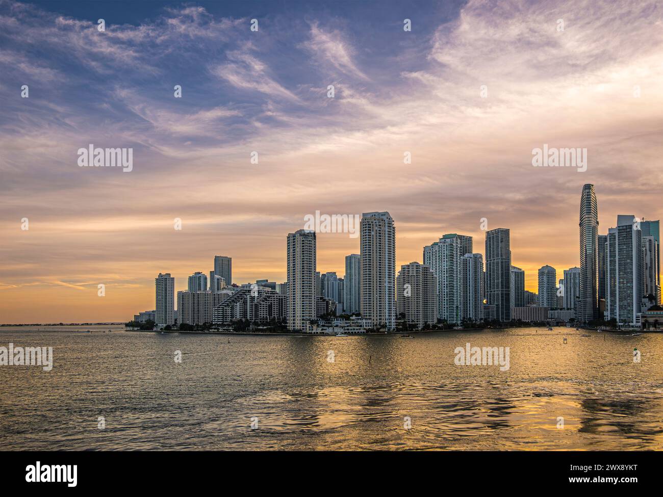 Miami, Florida, USA - July 29, 2023: Wide shot. Sunset sky over buildings on Brickell Key island at evening 19:43. Tequesta points in center. Both sid Stock Photo