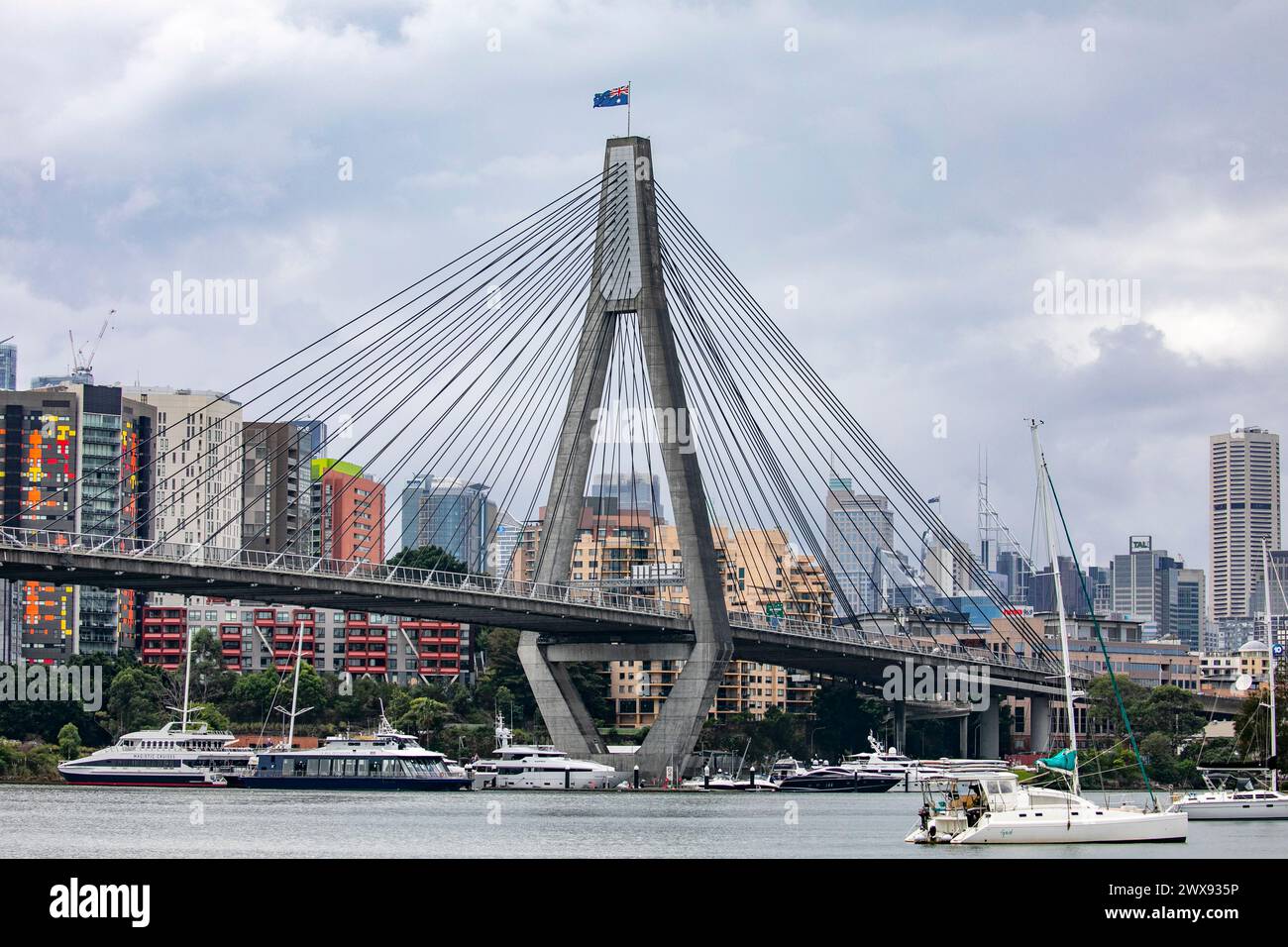 Anzac Bridge in Sydney connecting Pyrmont ( pictured) to Glebe, boats in the bay and Sydney city centre with high rise apartment buildings, Australia Stock Photo