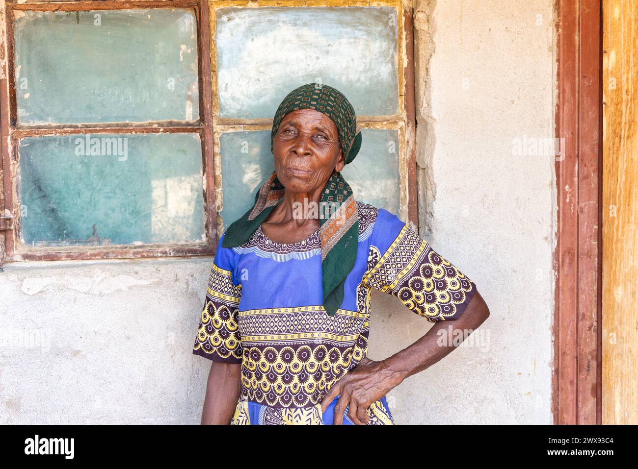 portrait african old woman sited on the porch in front of the house ...