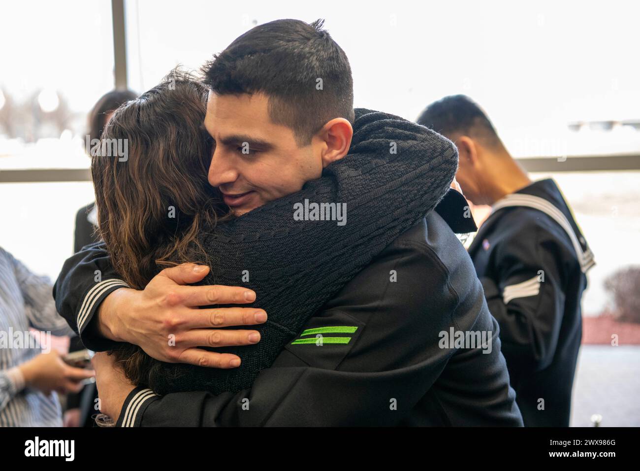 Great Lakes, Illinois, USA. 28th Mar, 2024. A Sailor embraces with a family member inside Midway Ceremonial Drill Hall after graduating from U.S. Navy Recruit Training Command's Pass in Review in Great Lakes, Illinois, Mar. 28, 2024. More than 40,000 recruits train annually at the Navy's only boot camp. (Credit Image: © Christopher M. O'Grady/U.S. Navy/ZUMA Press Wire) EDITORIAL USAGE ONLY! Not for Commercial USAGE! Stock Photo