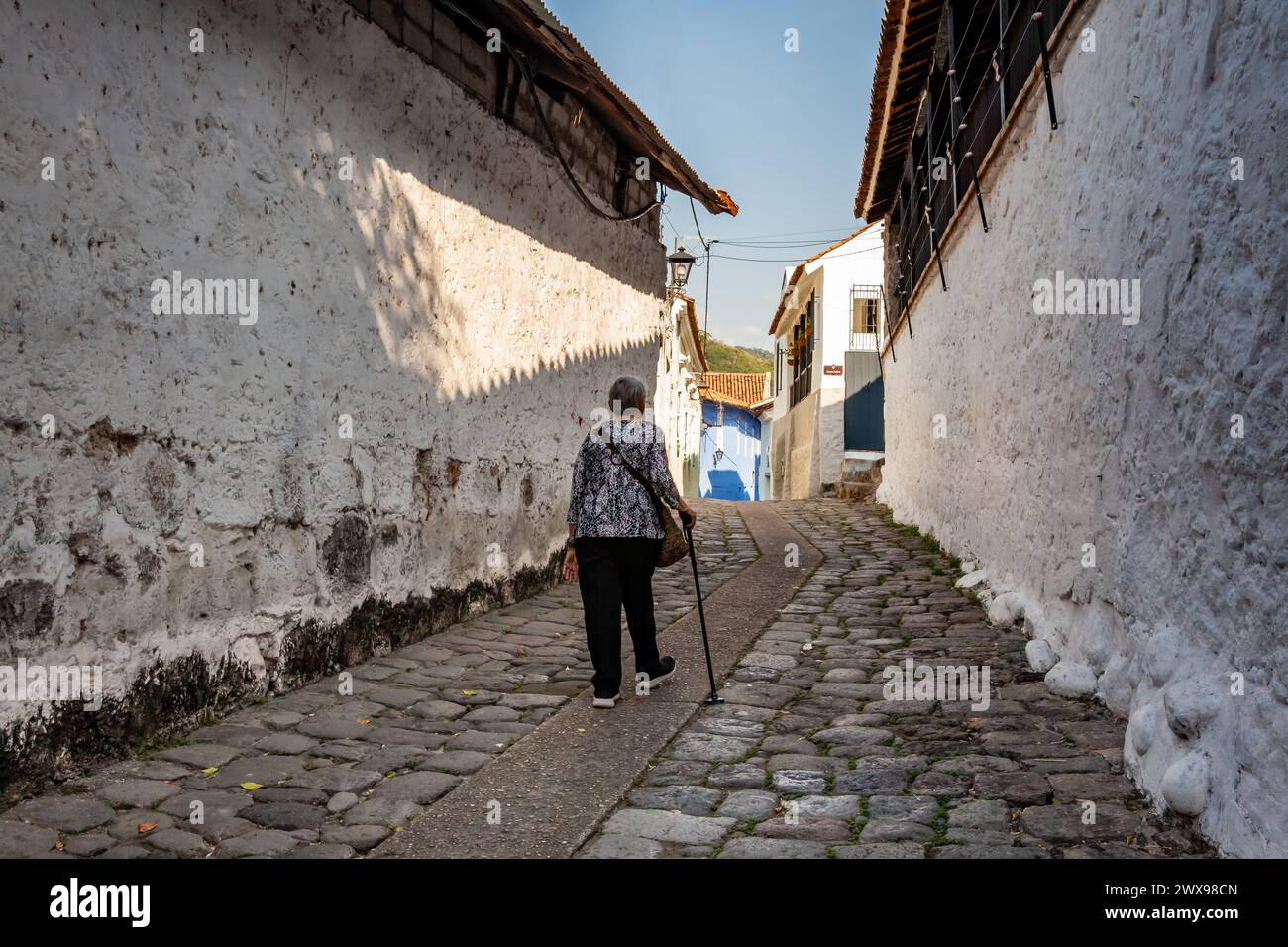 Senior woman at the historical street of traps located in the center of the heritage town of Honda in the department of Tolima in Colombia Stock Photo