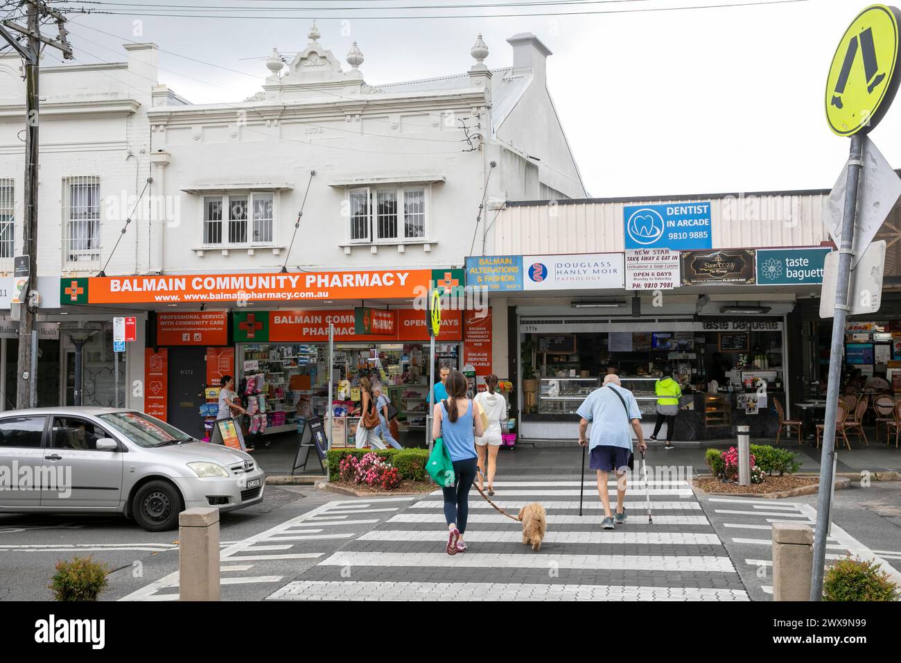 Balmain town centre Sydney, pelican zebra crossing with people cross the road, Balmain shops and pharmacy,Sydney,NSW,Australia Stock Photo