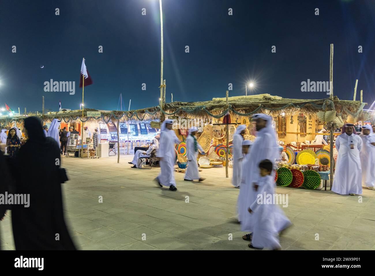 The busy street and the locals enjoying on outdoor activities during Doha Dhow Festival Located at the Katara Village. Stock Photo