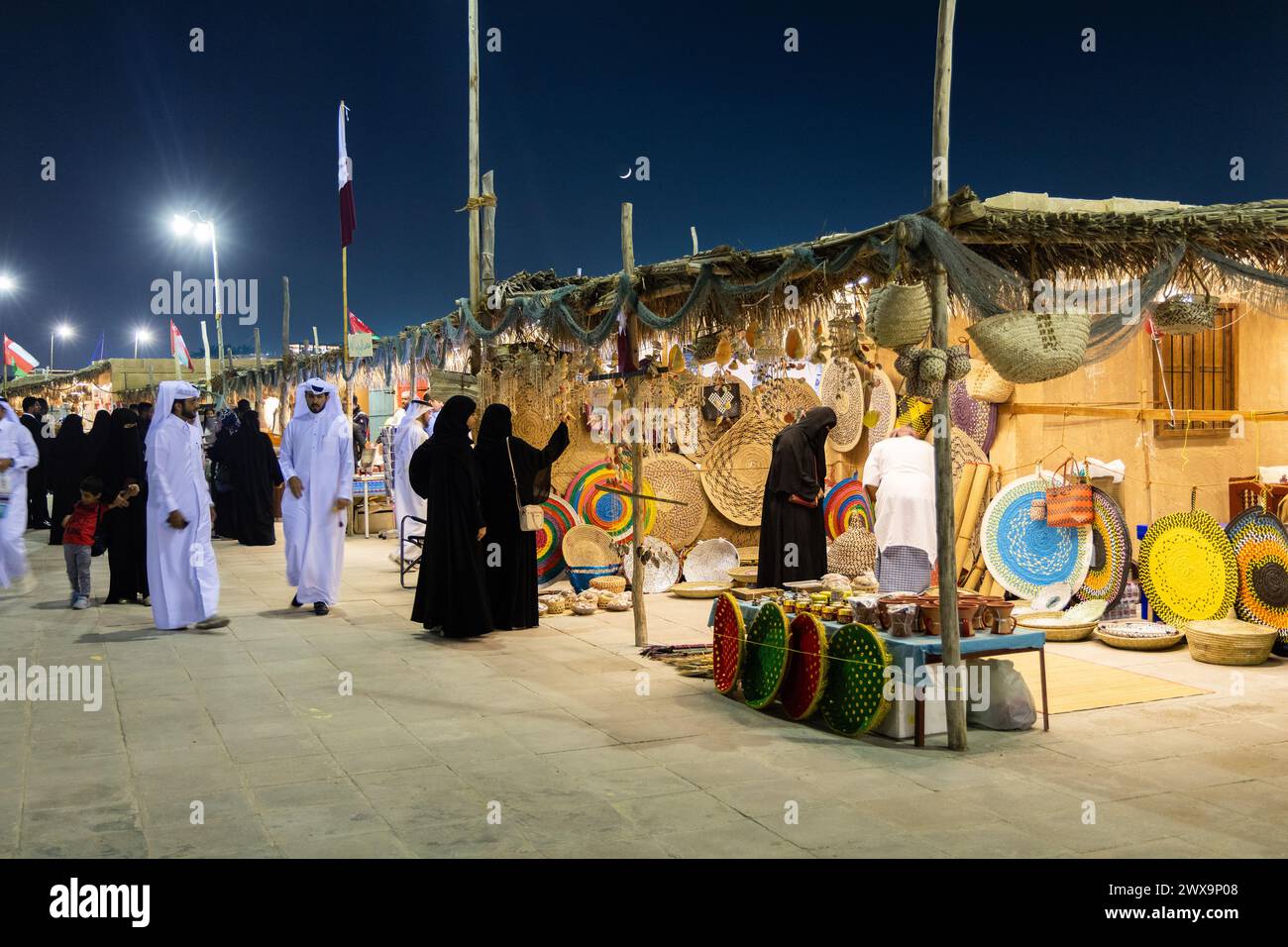 The busy street and the locals enjoying on outdoor activities during Doha Dhow Festival Located at the Katara Village. Stock Photo