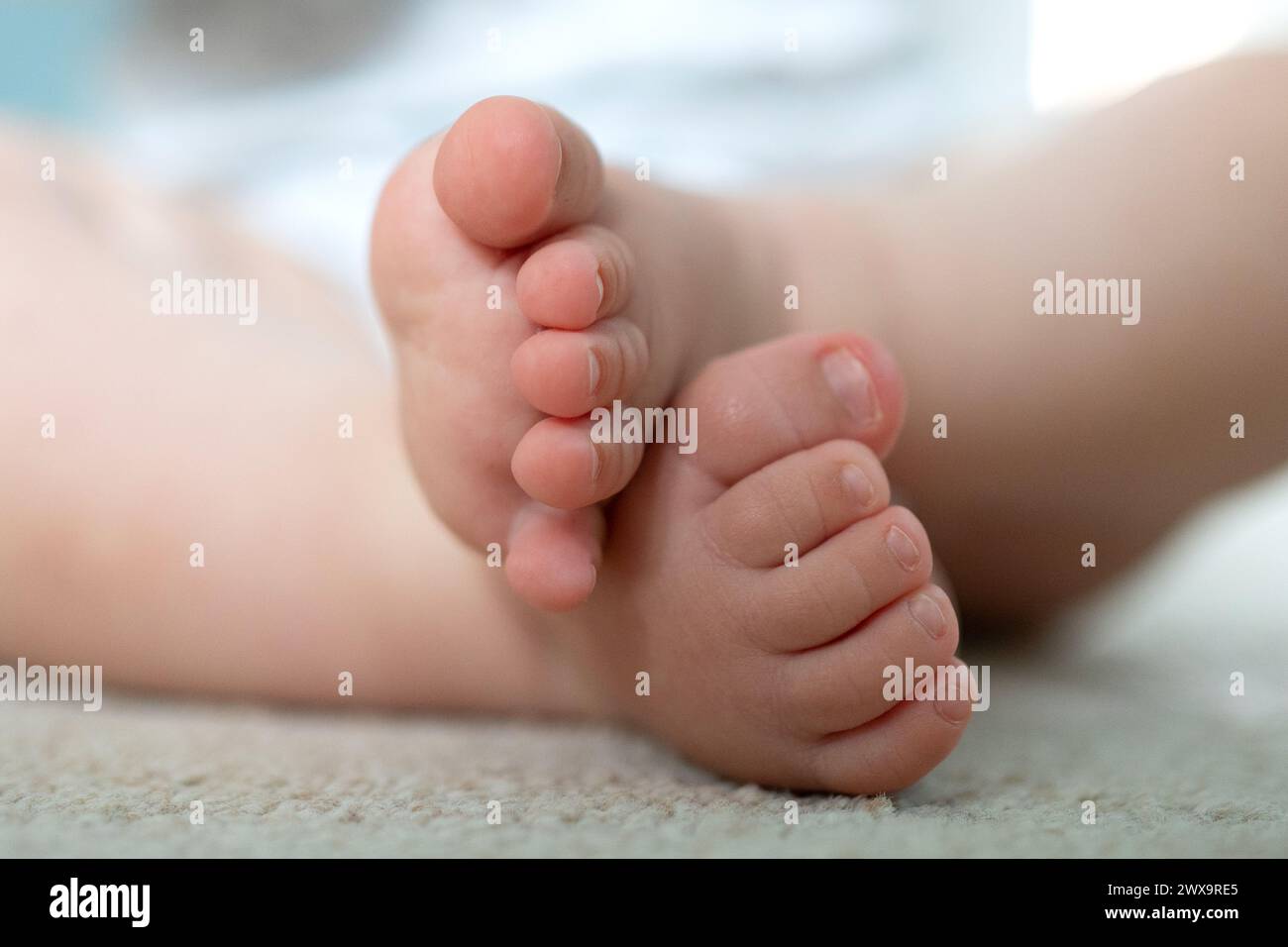 File photo dated 04/08/23 of a baby playing with toys at home in