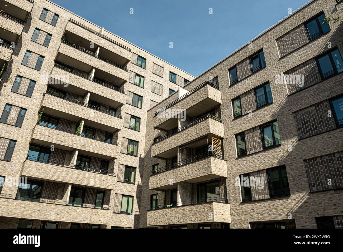 Facades with balconies of newly built flats. 1700 rental flats (partly social housing, but also owner-occupied) were built by 2023. Stock Photo