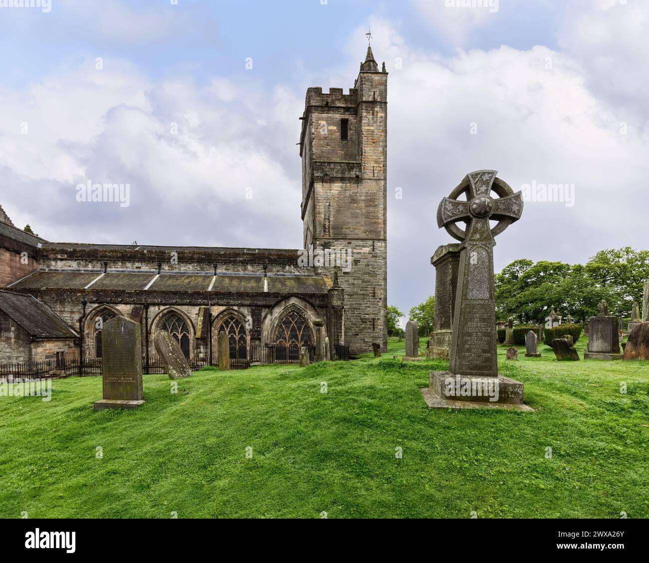 The Church of the Holy Rude stands in solemn grace in Stirling, Scotland, its gothic architecture and Celtic cross tombstones painting a picture of hi Stock Photo
