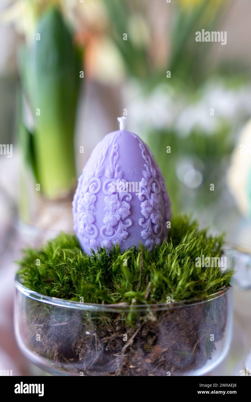 Colorful easter egg soy wax candle. Spring background Stock Photo
