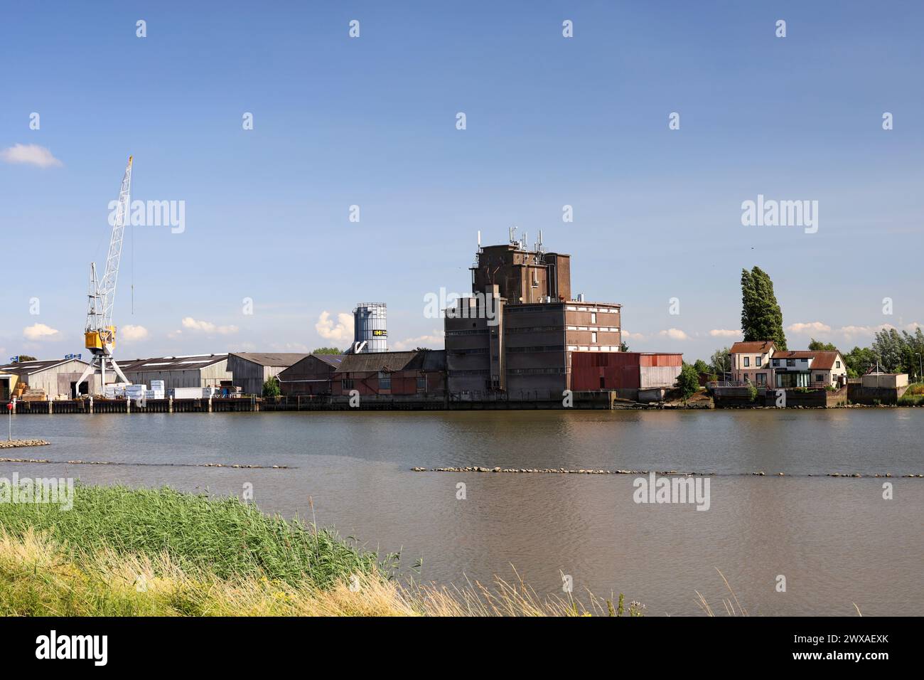 River Hollandsche IJssel with timber factory near Ouderkerk and Nieuwerkerk aan den IJssel in the Netherlands Stock Photo