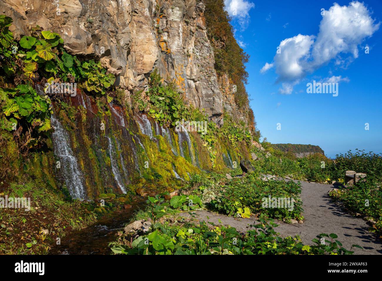 Rock with waterfalls, Iturup Island, South Kuriles Stock Photo