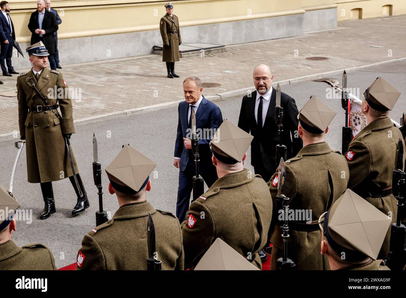 Prime Minister of Poland, Donald Tusk and Prime Minister of Ukraine, Denys Shmyhal greet the representative guards during bilateral meeting between Polish and Ukraine governments in the Polish PM's Chancellery on Ujazdowska Street in Warsaw, the capital of Poland on March, 28, 2024. Stock Photo