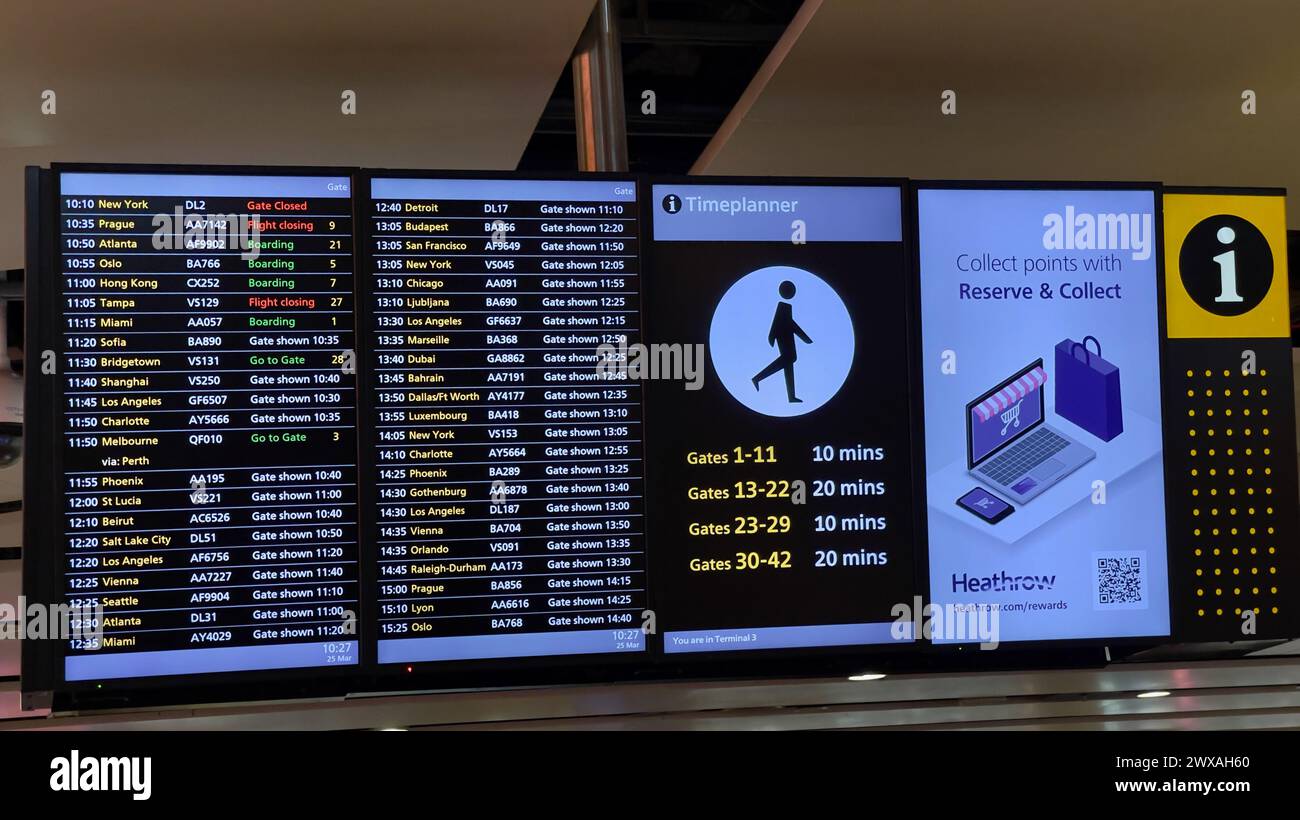 London,England: March 25.2024: Travelers checking the digital flight departure board for flight details at Heathrow airport in London,England Stock Photo