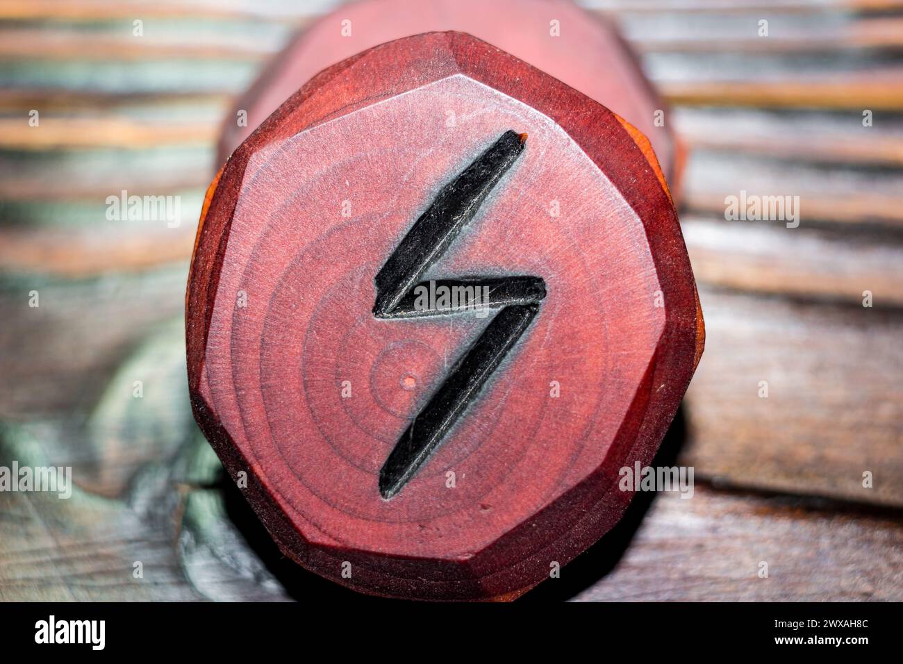 Rune Sowilo (Sigel, Sol) red color carved from wood on a wooden ...