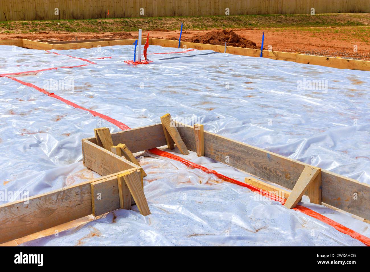 Ground is covered with waterproofing membrane before foundation is poured Stock Photo