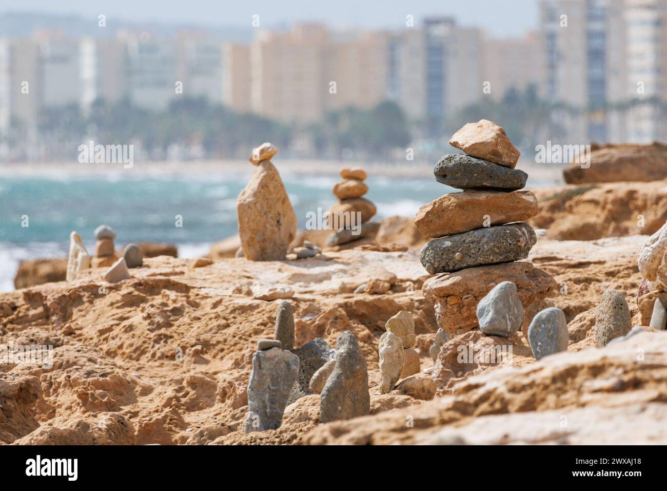 Stone cairns on the beach of the Agua Amarga salt marsh, Alicante, Spain Stock Photo
