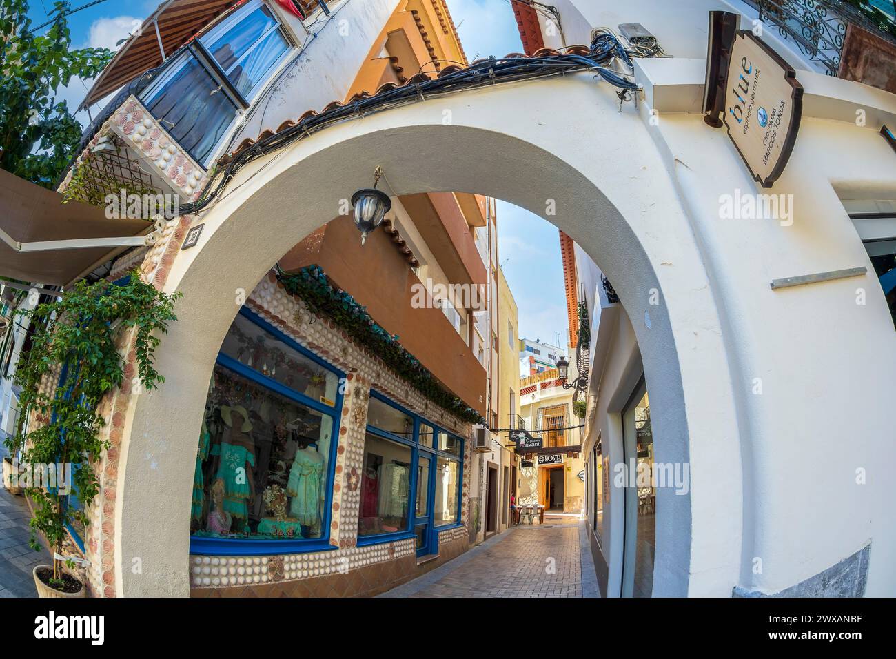 BENIDORM, SPAIN - AUGUST 14, 2020: View with small and picturesque street with shops, located in the historical center of the city. Stock Photo