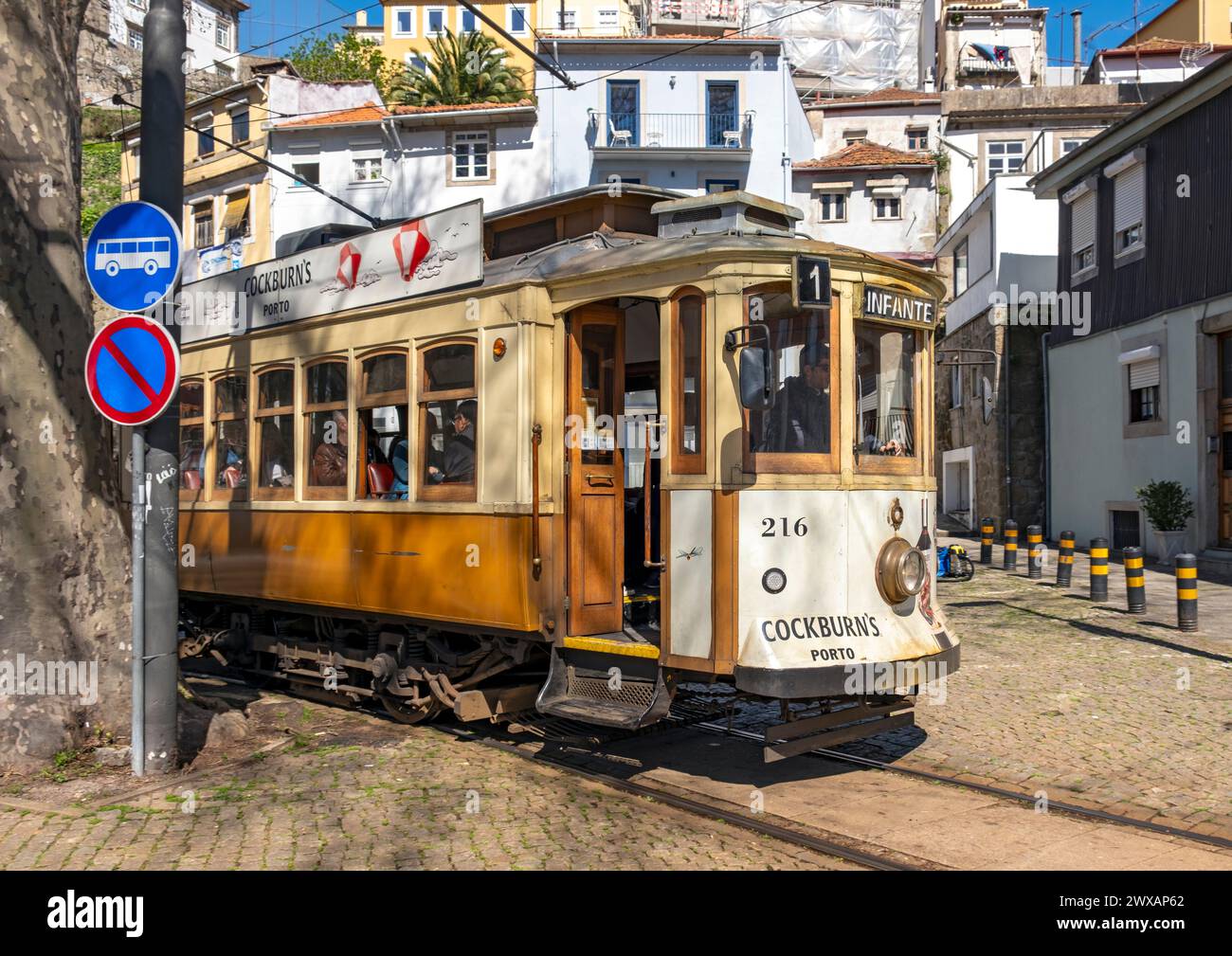 A historic tram weaves its way through the streets of Porto's center, Portugal Stock Photo