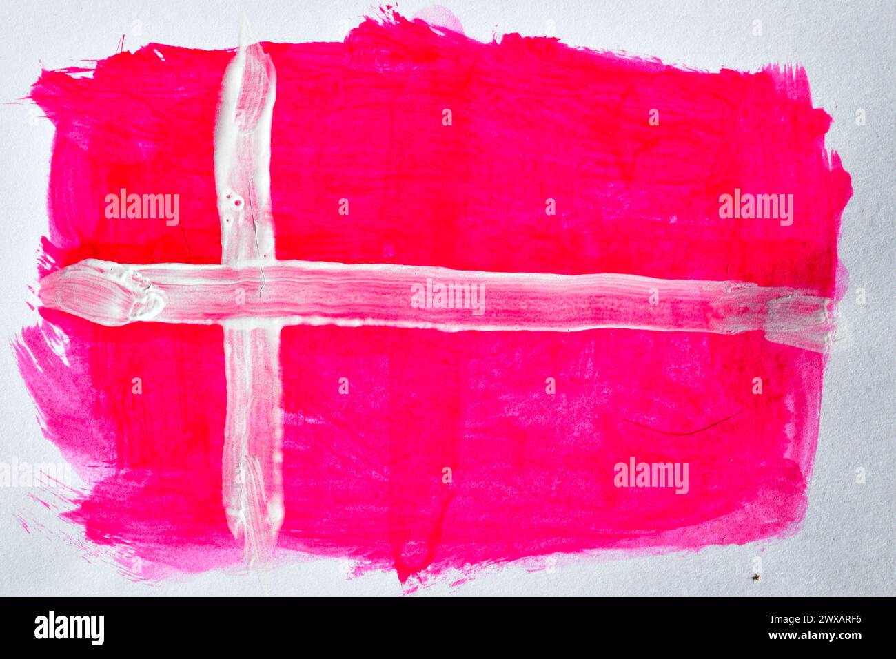 White cross on red painted with watercolors on a white background similar to the flag of Denmark. Stock Photo