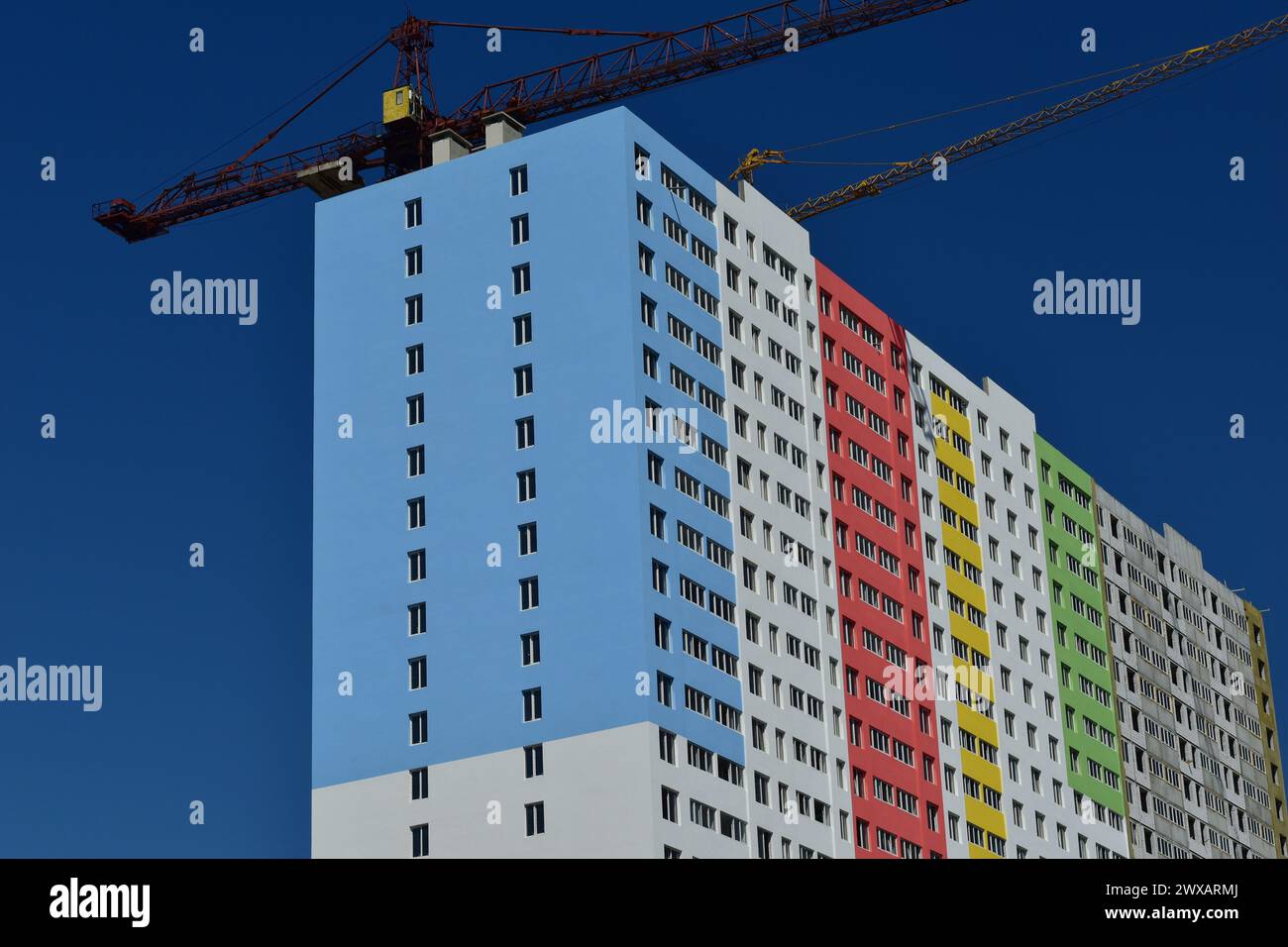 View from the side of a colorful high-rise building under construction ...