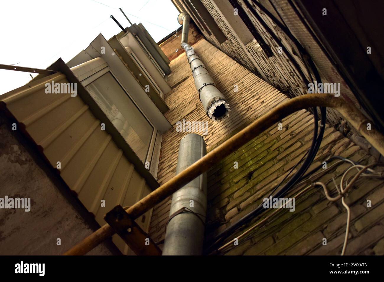 The picture shows the height of the building and the falling drops from the roof of the house. Stock Photo