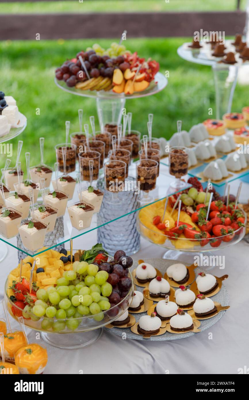 A table filled with an array of delectable desserts such as cakes, pastries, cookies, and tarts, meticulously displayed and tempting for indulgence. Stock Photo