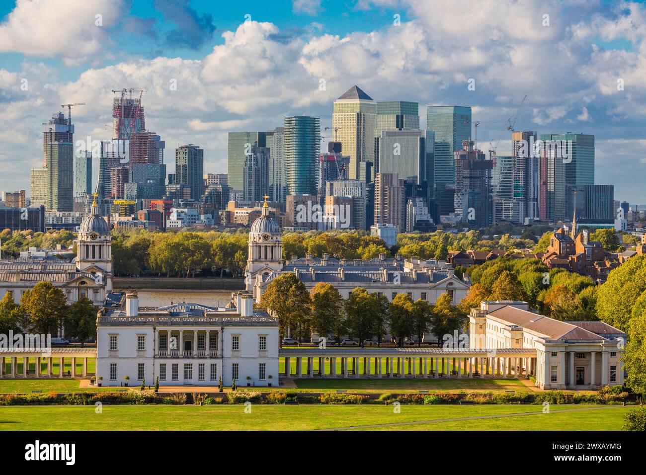 London at Sunset Light, England,  Skyline View Of Greenwich College and Canary Wharf At Golden Hour Sunset With Blue Sky And Clouds Stock Photo