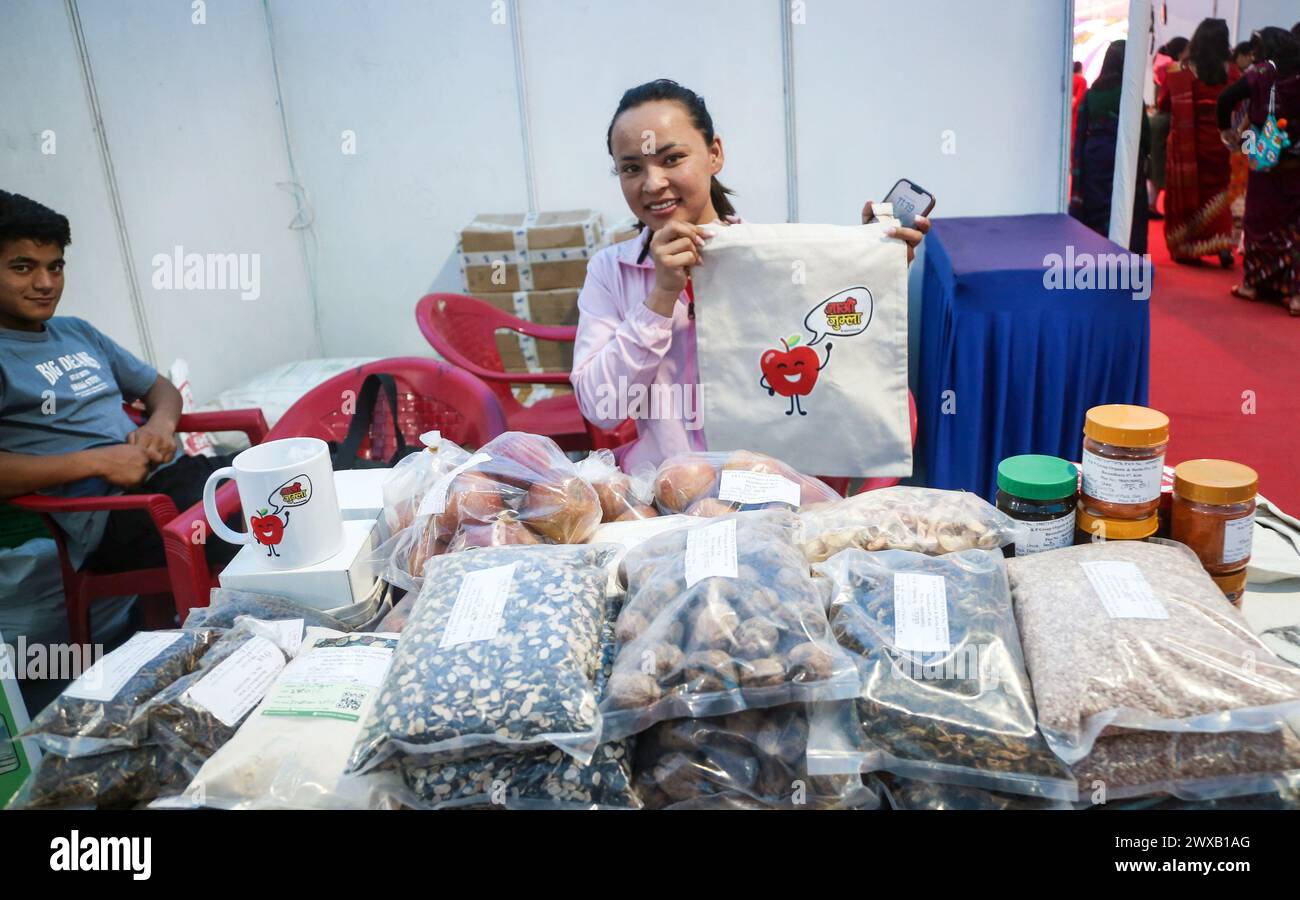 Kathmandu. 29th Mar, 2024. A lady displays the bag printed with ''let's go Jumla'', promoting the products of Jumla at a stall of 7th International Women's Trade Expo 2024 in Kathmandu, Nepal on March 29, 2024. Jumla is a district about 830 km from Kathmandu lies in western Nepal, popular for apples, redrice, yarsagumba and the orgins of Nepali language. (Credit Image: © Sunil Sharma/ZUMA Press Wire) EDITORIAL USAGE ONLY! Not for Commercial USAGE! Credit: ZUMA Press, Inc./Alamy Live News Stock Photo