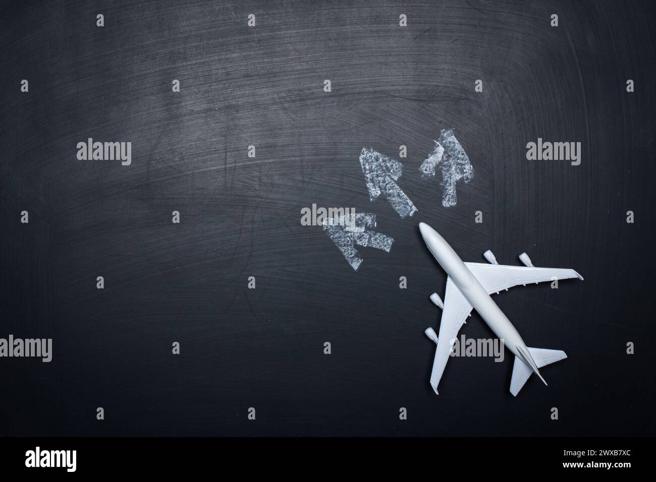 toy airplane over chalkboard background and arrows drawings Stock Photo ...