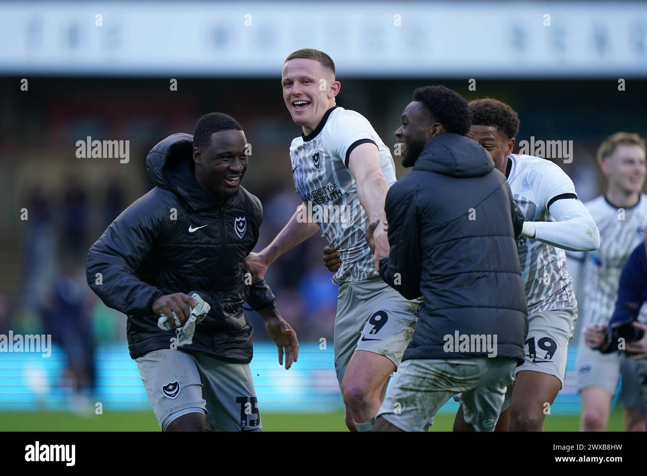 Goalscorer Portsmouth's Colby Bishop (centre) celebrates with team mates at full time during the Sky Bet League One match at Adams Park, Wycombe. Picture date: Friday March 29, 2024. Stock Photo