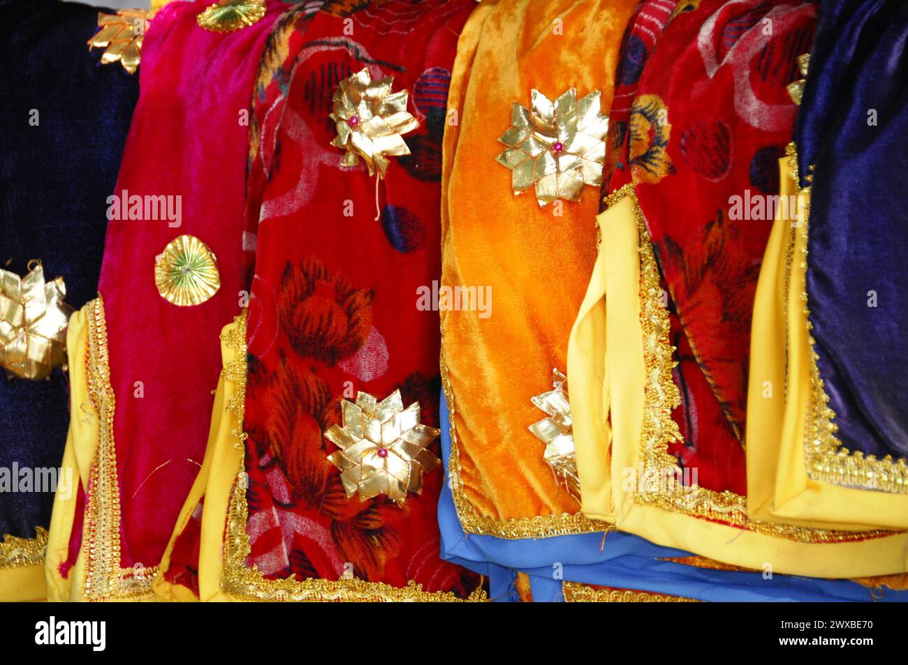 Market stall, A collection of luxurious, patterned fabrics and clothing