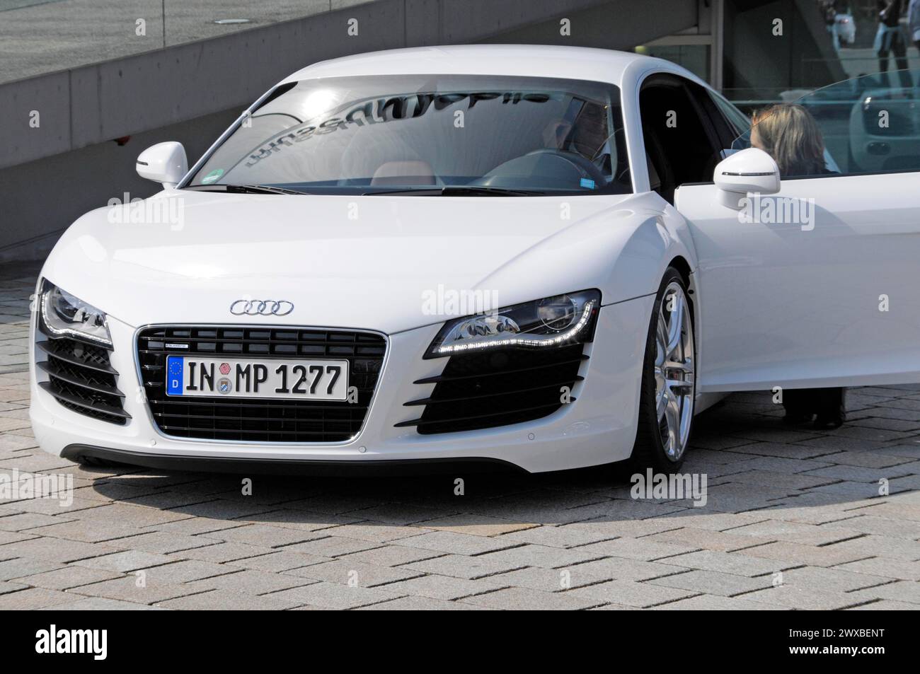 White Audi R8 with open driver's door and a woman at the wheel, Museum ...