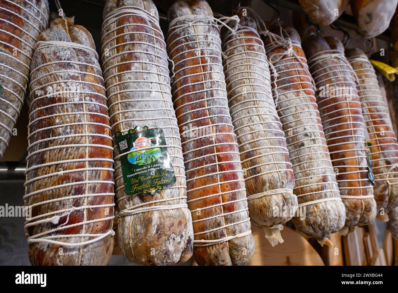 Strung Capocollo (capicola), a regional delicacy, hang in a butcher's