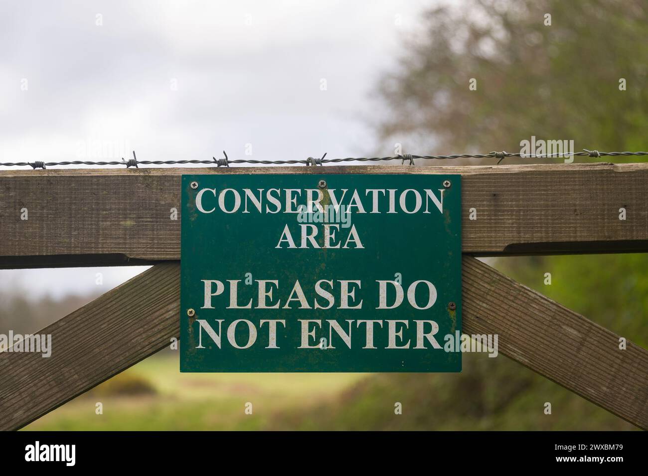 Conservation area, please do not enter sign on a wooden gate. Stock Photo