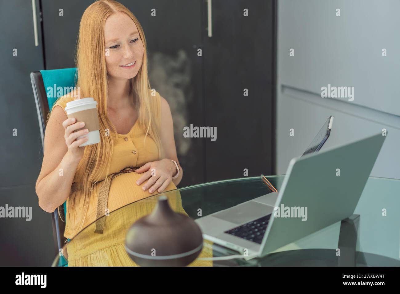 Expectant woman enhances work environment, using an aroma diffuser for