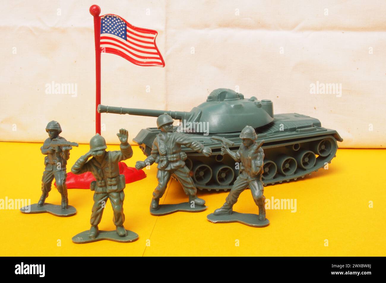 Retro toy soldiers with guns, binoculars, an army tank and the American stars and stripes flag Stock Photo