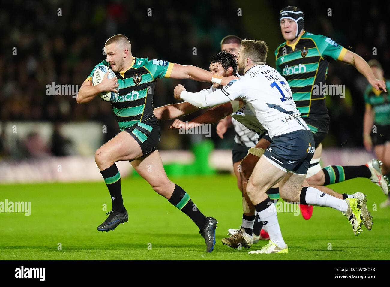 Northampton Saints' Ollie Sleightholme (left) goes past Saracens’ Elliot Daly during the Gallagher Premiership match at cinch Stadium at Franklin's Gardens, Northampton. Picture date: Friday March 29, 2024. Stock Photo