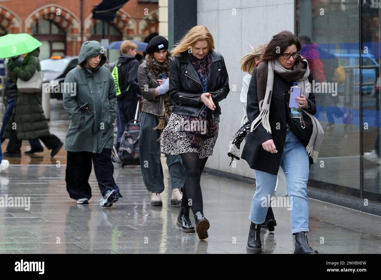 Women Are Caught In The Wet Weather In Central London Weather Women are caught in the wet weather in central london weather