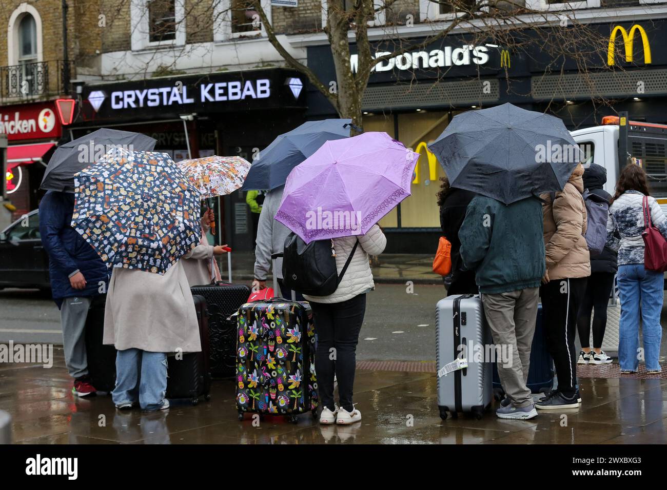 Women Shelter Under Umbrellas During The Wet Weather In Central London Women shelter under umbrellas during the wet weather in central london