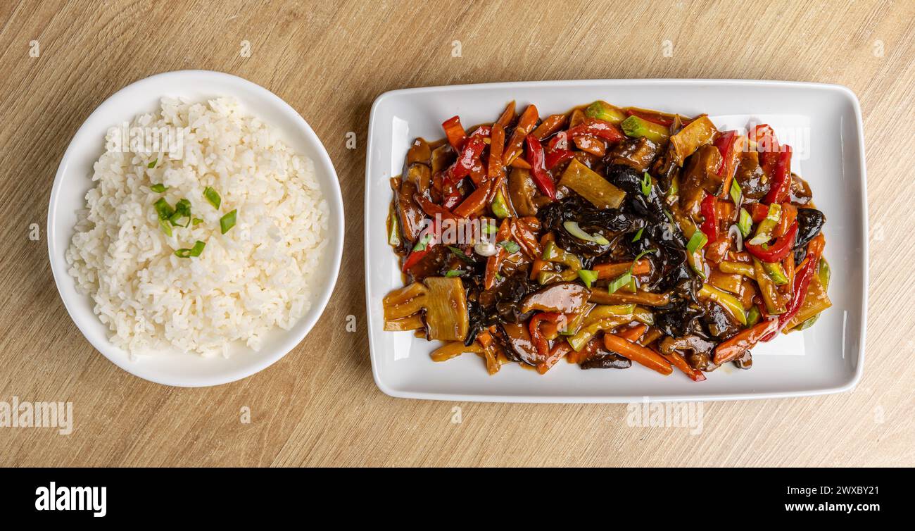 Appetizing colorful vegetables in Asian style served with white rice on plate Stock Photo