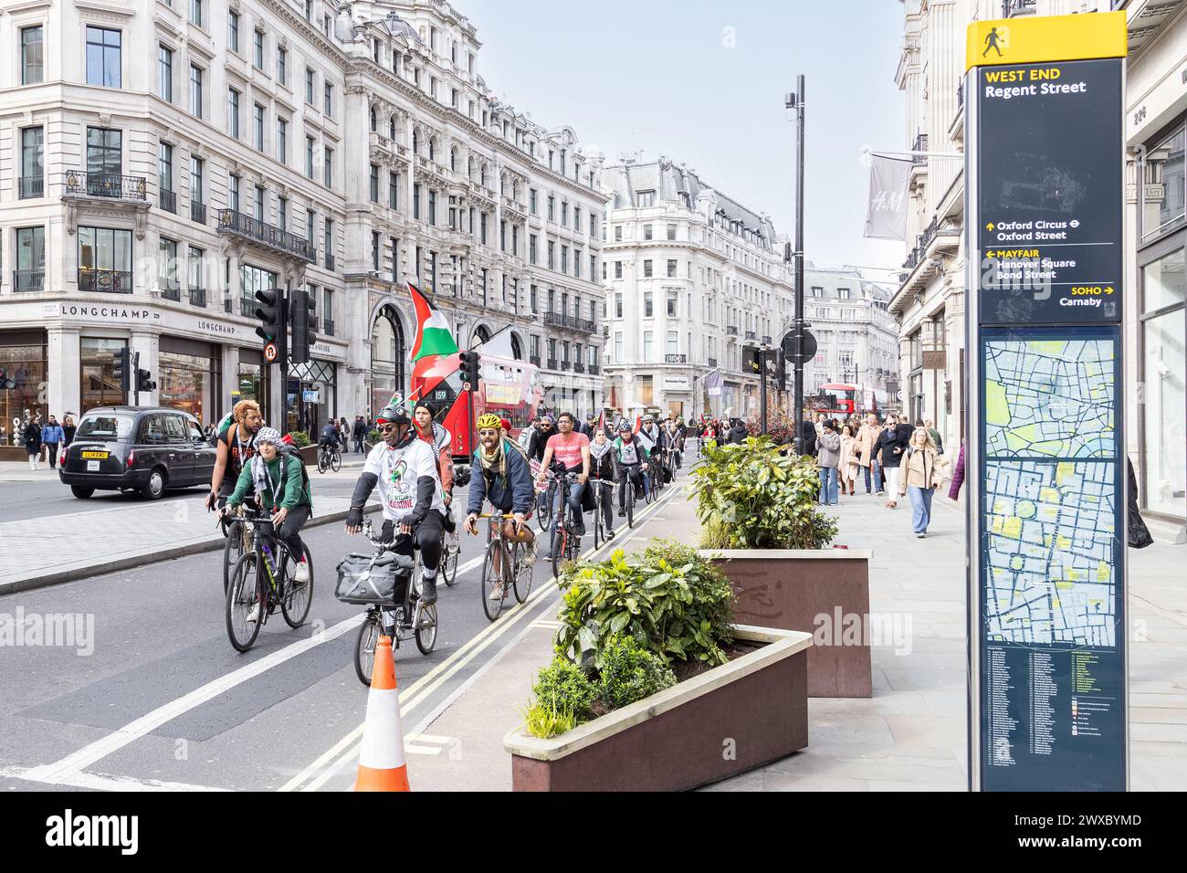 Pro Palestine supporters show their support while cycling through Westminster. Israel Hamas war - pro Palestinian supporters riding through London. Stock Photo