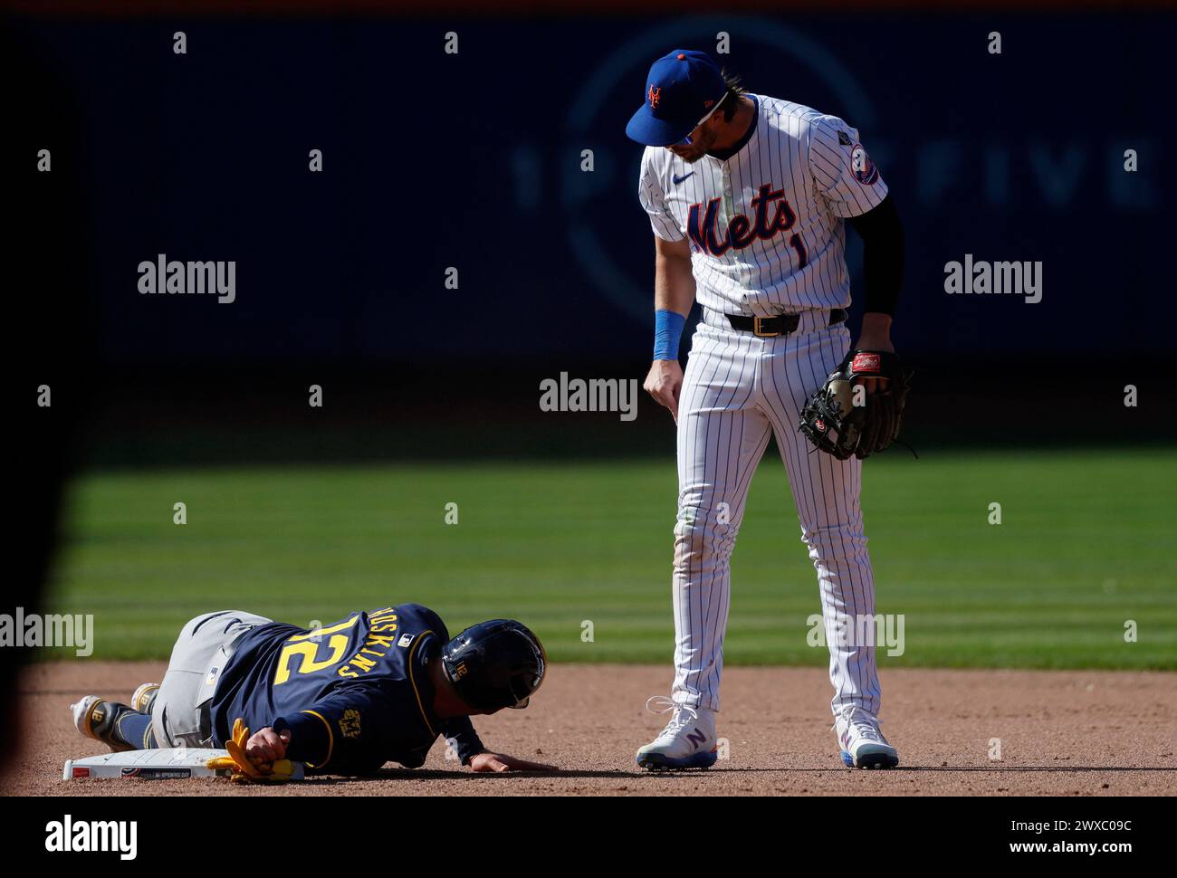 Queens, United States. 29th Mar, 2024. New York Mets Jeff McNeil reacts after Milwaukee Brewers Rhys Hoskins slides into him aggressively at 2nd base in the 8th inning on opening day at Citi Field on Friday, March 29, 2024 in New York City. Photo by John Angelillo/UPI Credit: UPI/Alamy Live News Stock Photo