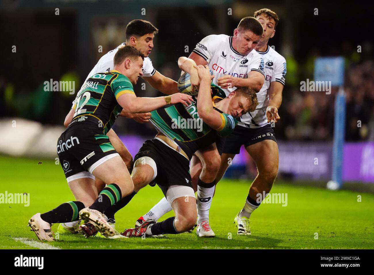 Northampton Saints' Fin Smith is tackled by Saracens’ Owen Farrell during the Gallagher Premiership match at cinch Stadium at Franklin's Gardens, Northampton. Picture date: Friday March 29, 2024. Stock Photo