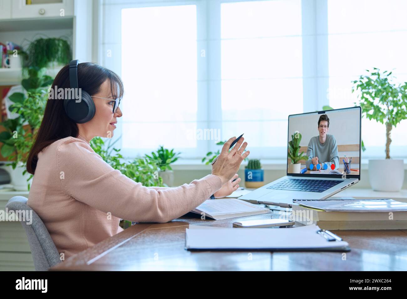 Female teacher having video conference, online test lesson with college ...