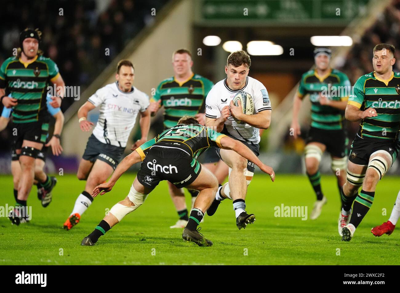Saracens’ Theo Dan (centre right) is tackled by Northampton Saints' James Ramm during the Gallagher Premiership match at cinch Stadium at Franklin's Gardens, Northampton. Picture date: Friday March 29, 2024. Stock Photo