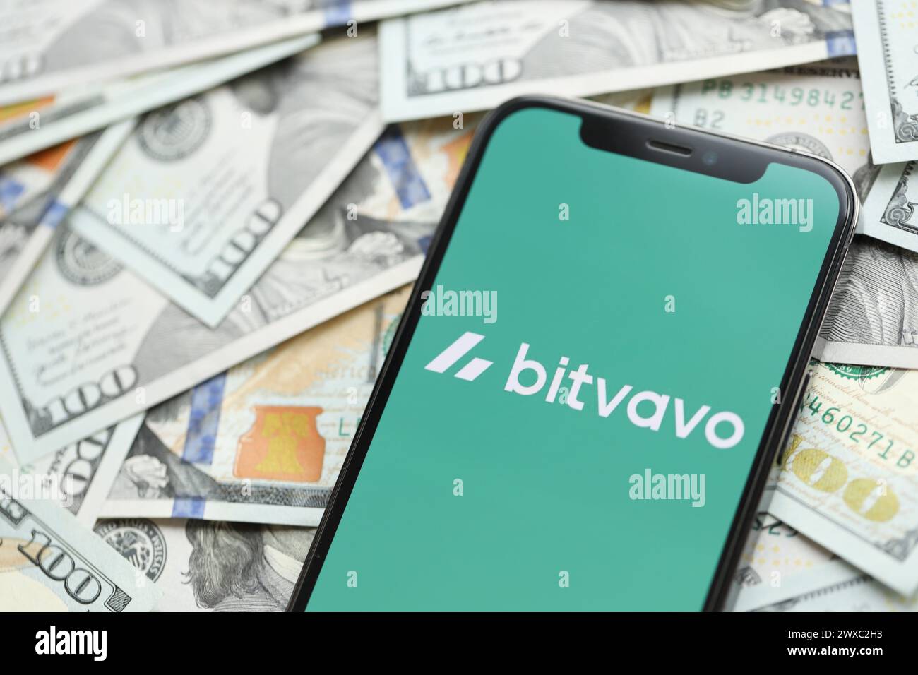 KYIV, UKRAINE - MARCH 15, 2024 Bitvavo logo on iPhone display screen with  many hundred dollar bills. Cryptocurrency exchange portal Stock Photo -  Alamy