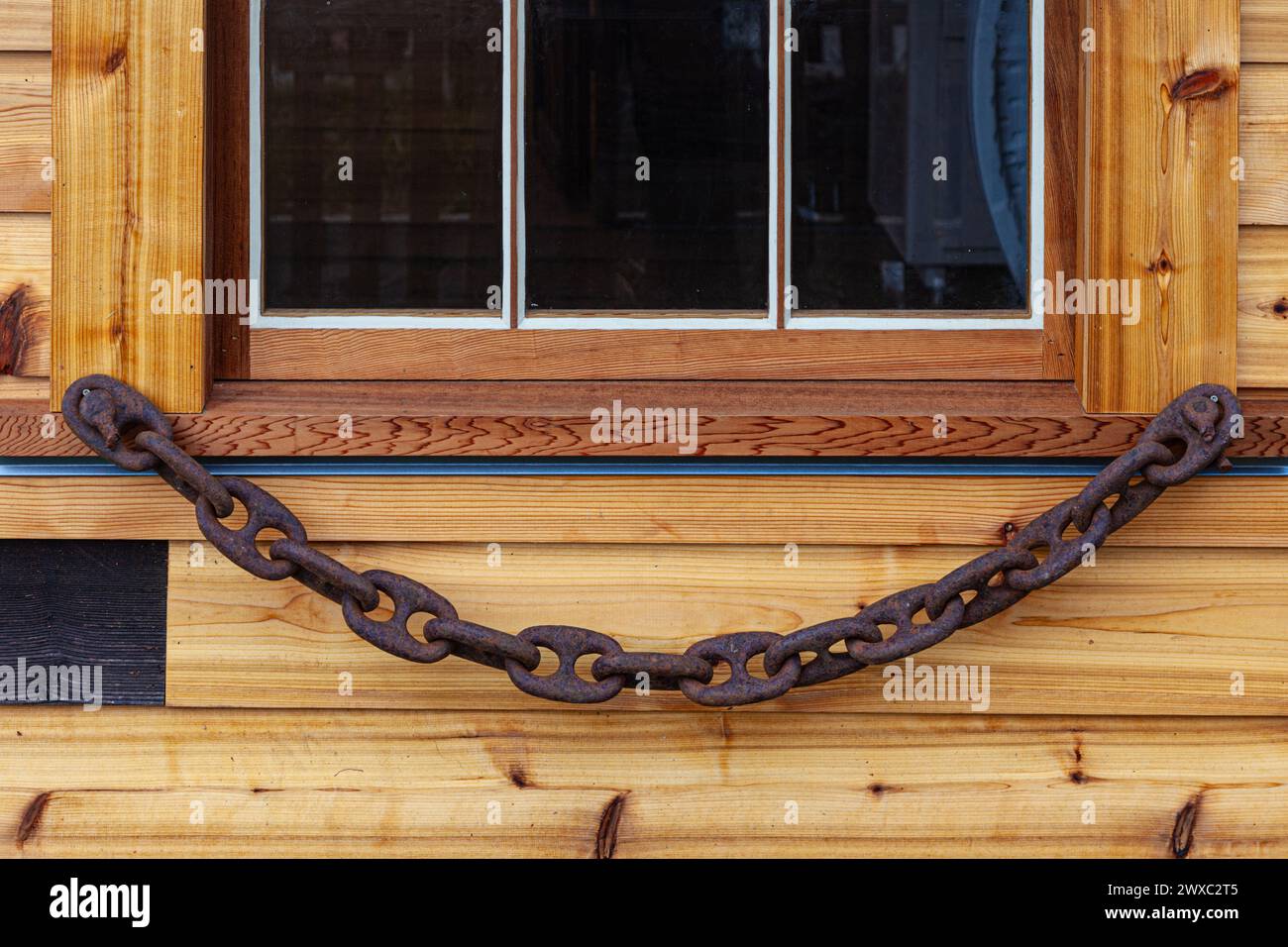 Rusty chain decorating a window sill at the Britannia Shipyard in Steveston  Canada Stock Photo