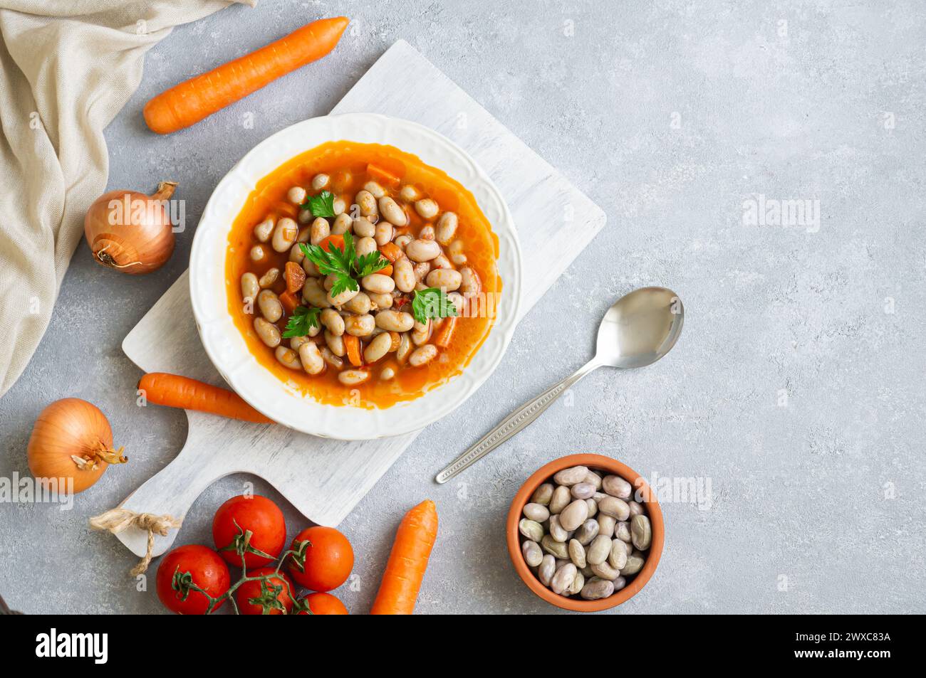 Traditional Turkish food kidney beans with olive oil , onion and tomato paste in a ceramic plate on rustic background Stock Photo