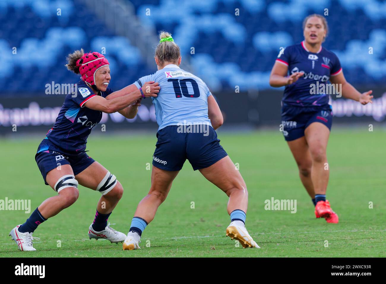 Sydney, Australia. 29th Mar, 2024. Arabella McKenzie of the Waratahs is tackled by Melanie Kawa of the Rebels during the Super Rugby Women's 2024 Rd3 match between the Waratahs and the Rebels at Allianz Stadium on March 29, 2024 in Sydney, Australia Credit: IOIO IMAGES/Alamy Live News Stock Photo